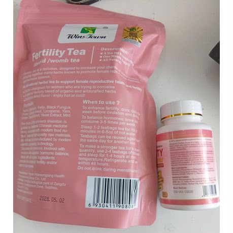 Back view of WinsTown fertility womb tea pouch and fertility support tablets